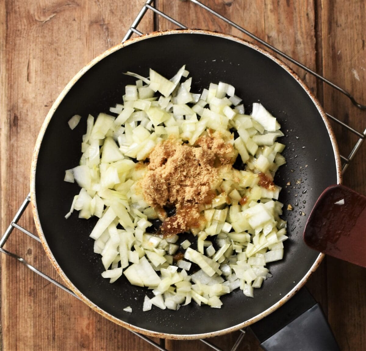 Chopped onions with brown sugar in pan.