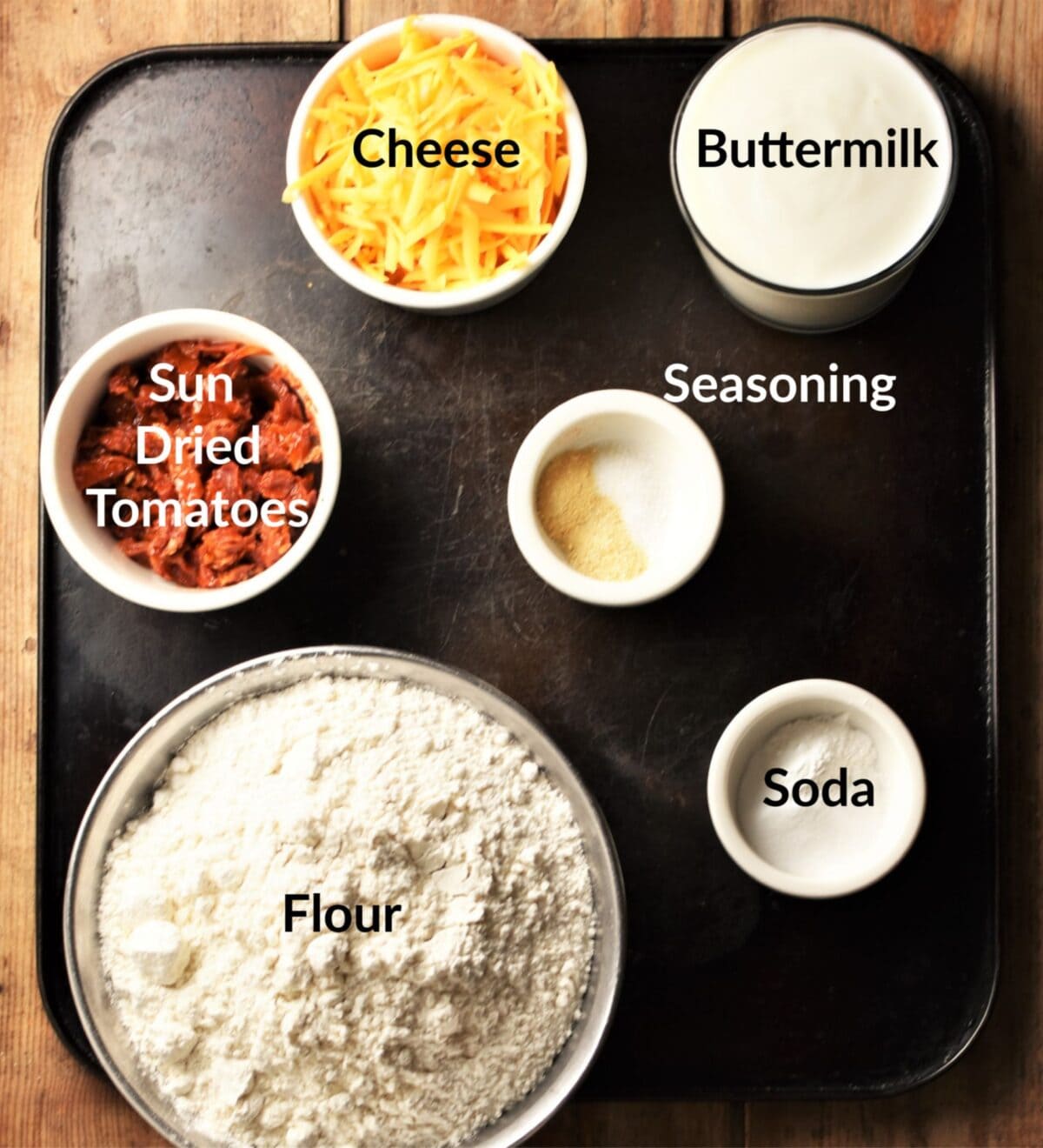 Sun dried tomato bread ingredients in individual dishes.