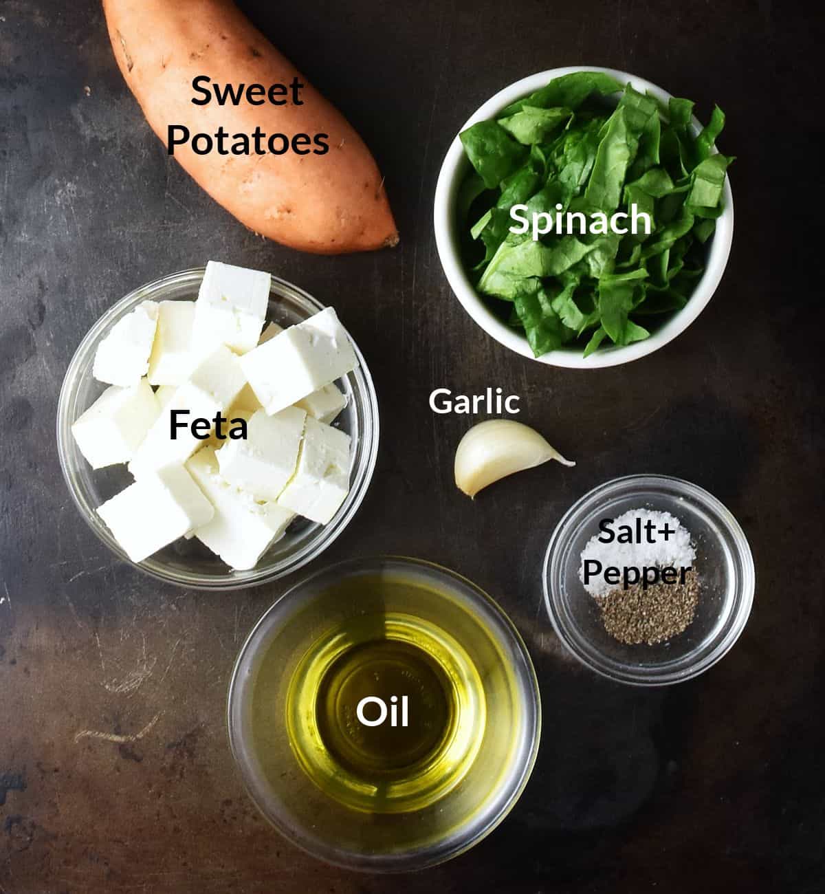 Top down view of sweet potato with spinach ingredients in individual dishes.