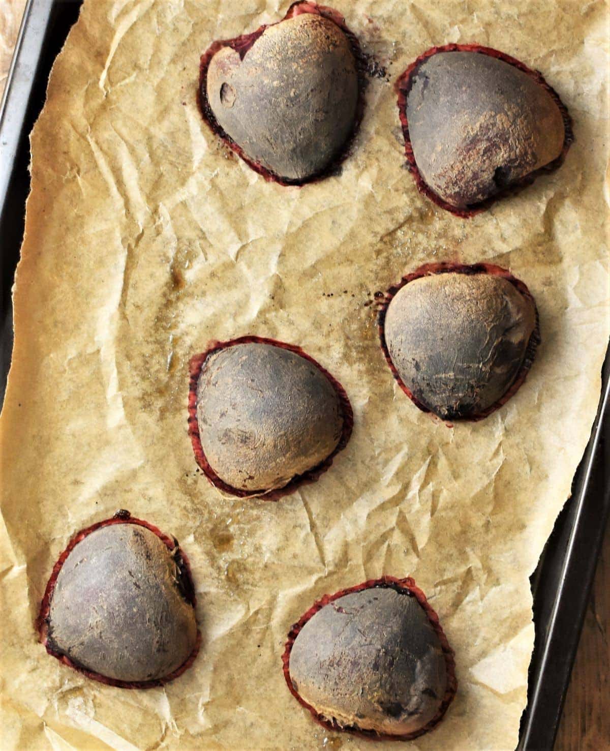 6 roasted beetroot halves on top of parchment.