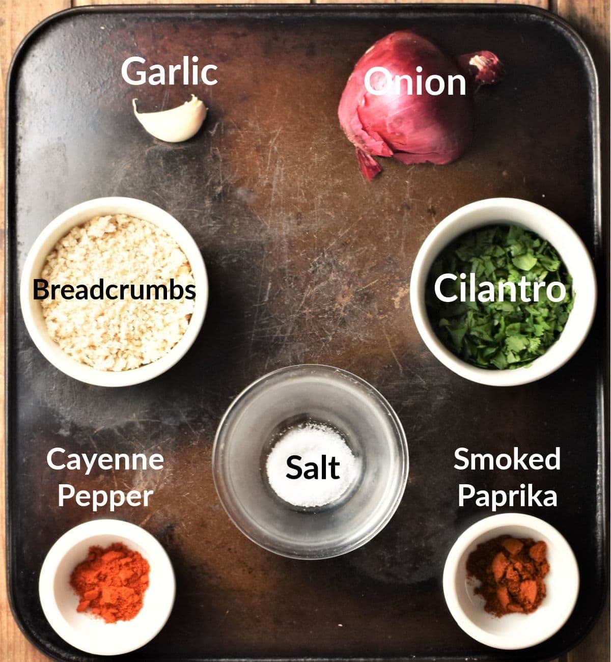 Spicy chicken burgers ingredients in individual dishes.