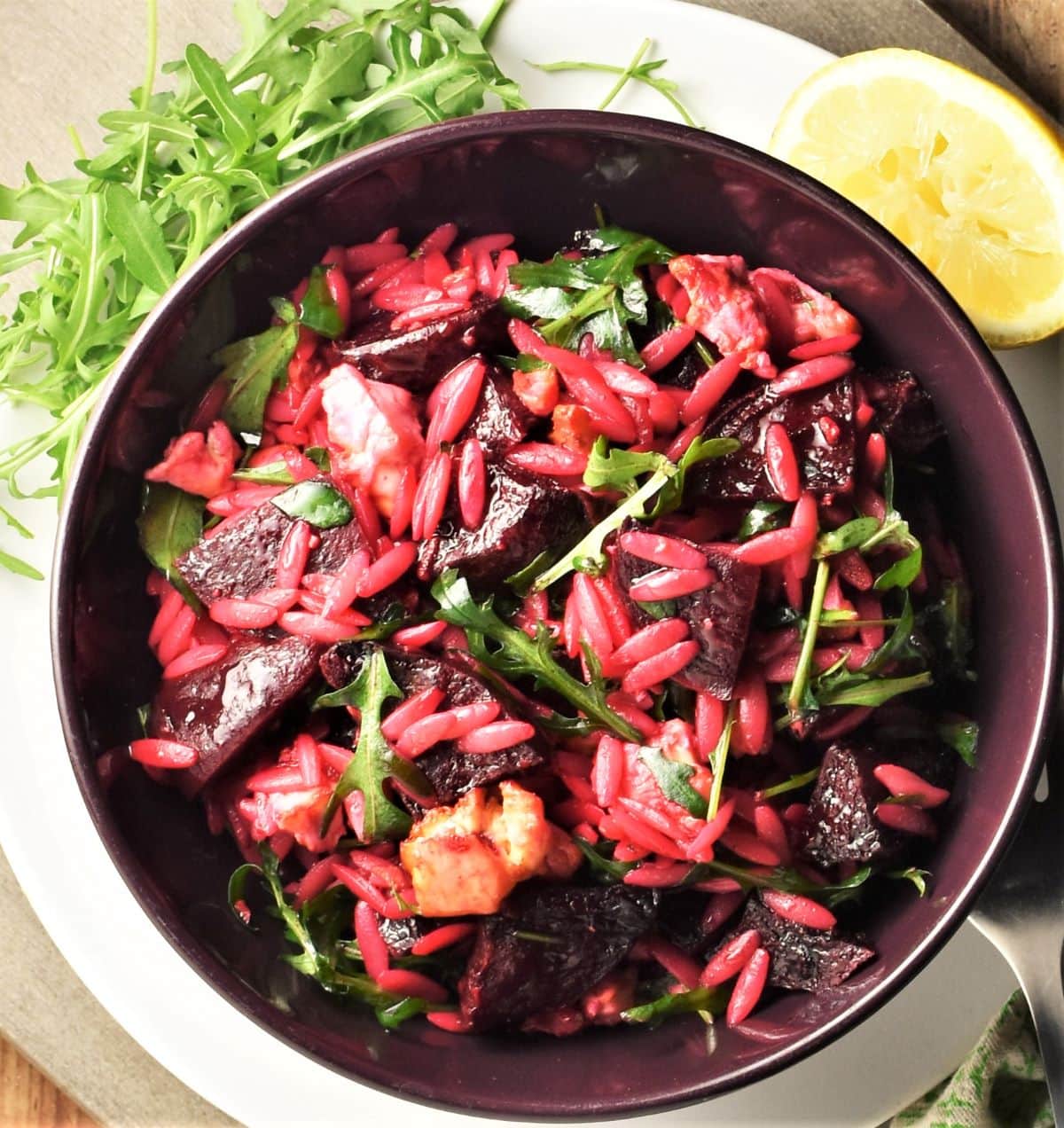 Beet feta salad with pasta in purple bowl.