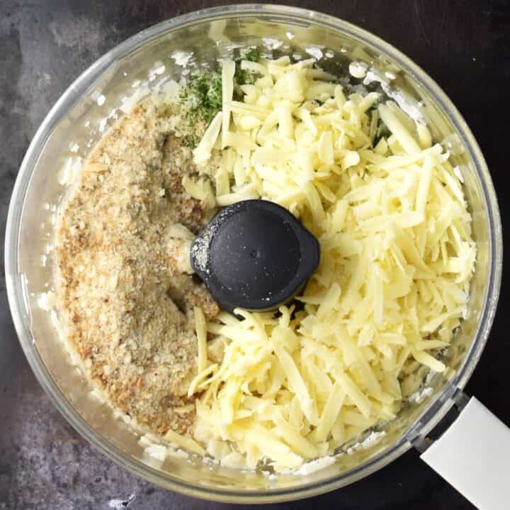 Grated cheese and breadcrumbs with cauliflower in food processor.