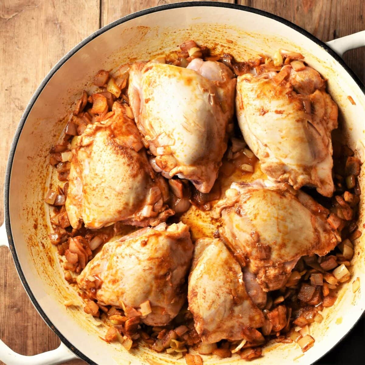 6 skinless chicken thighs with spices in large shallow dish.