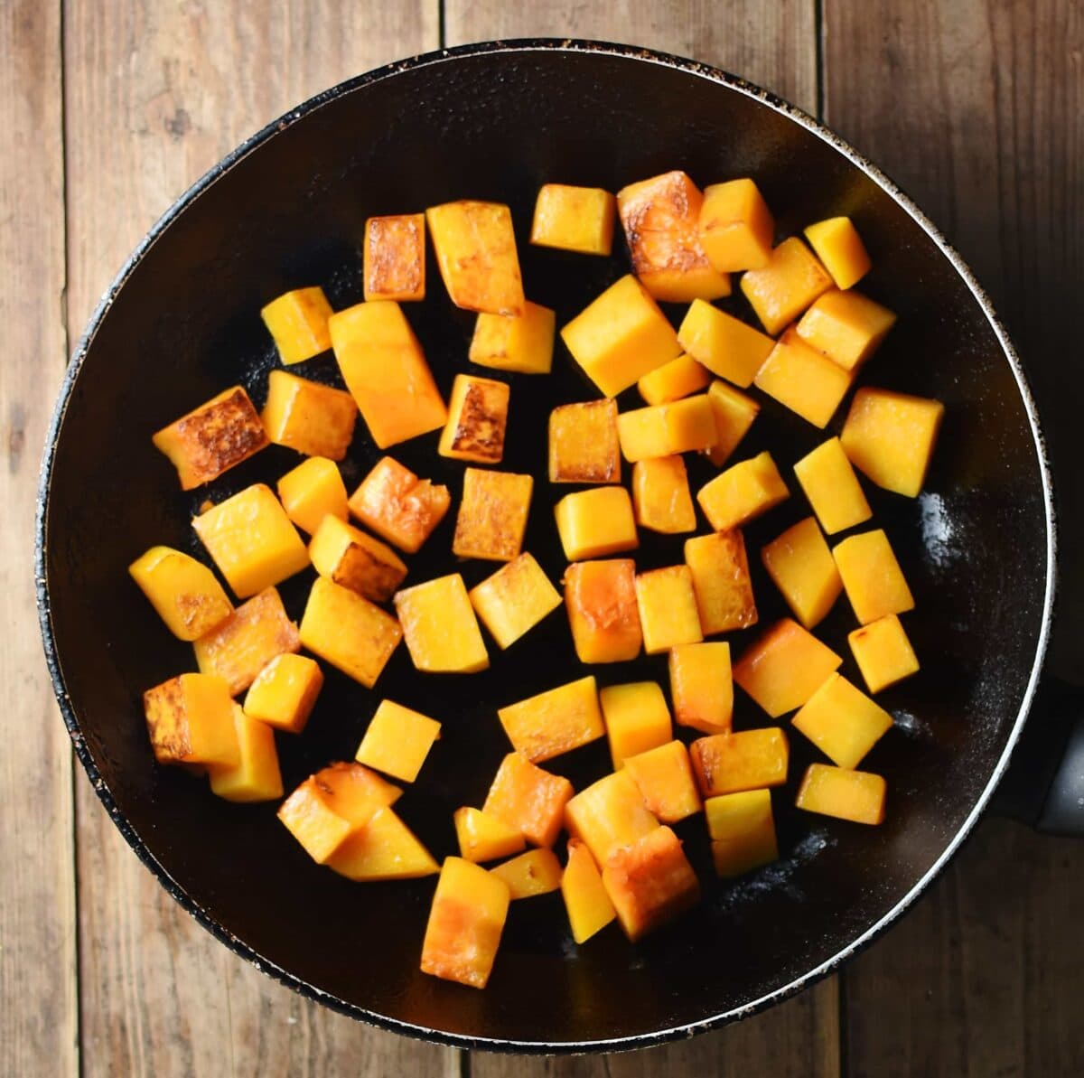 Cubed fried squash in large pan.