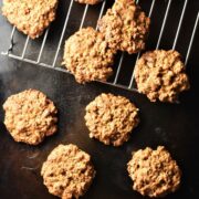 Healthy peanut butter oatmeal cookies on top of black tray and rack.