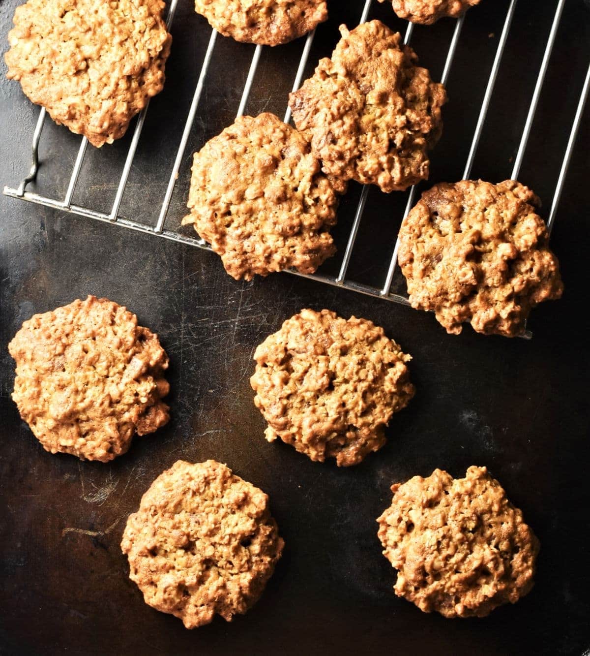 Healthy peanut butter oatmeal cookies on top of black tray and rack.