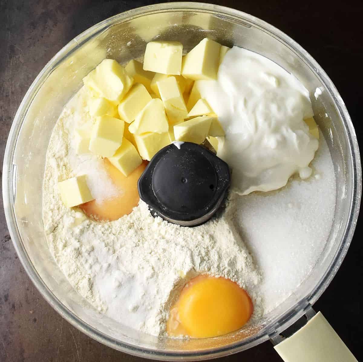 Cake pastry ingredients in food processor bowl.