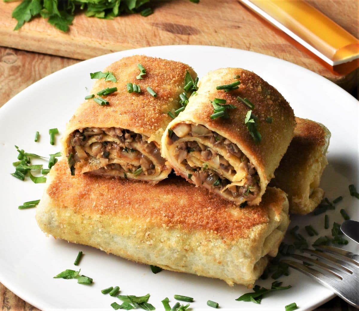 Side view of fried mushroom krokiety on top of plate.