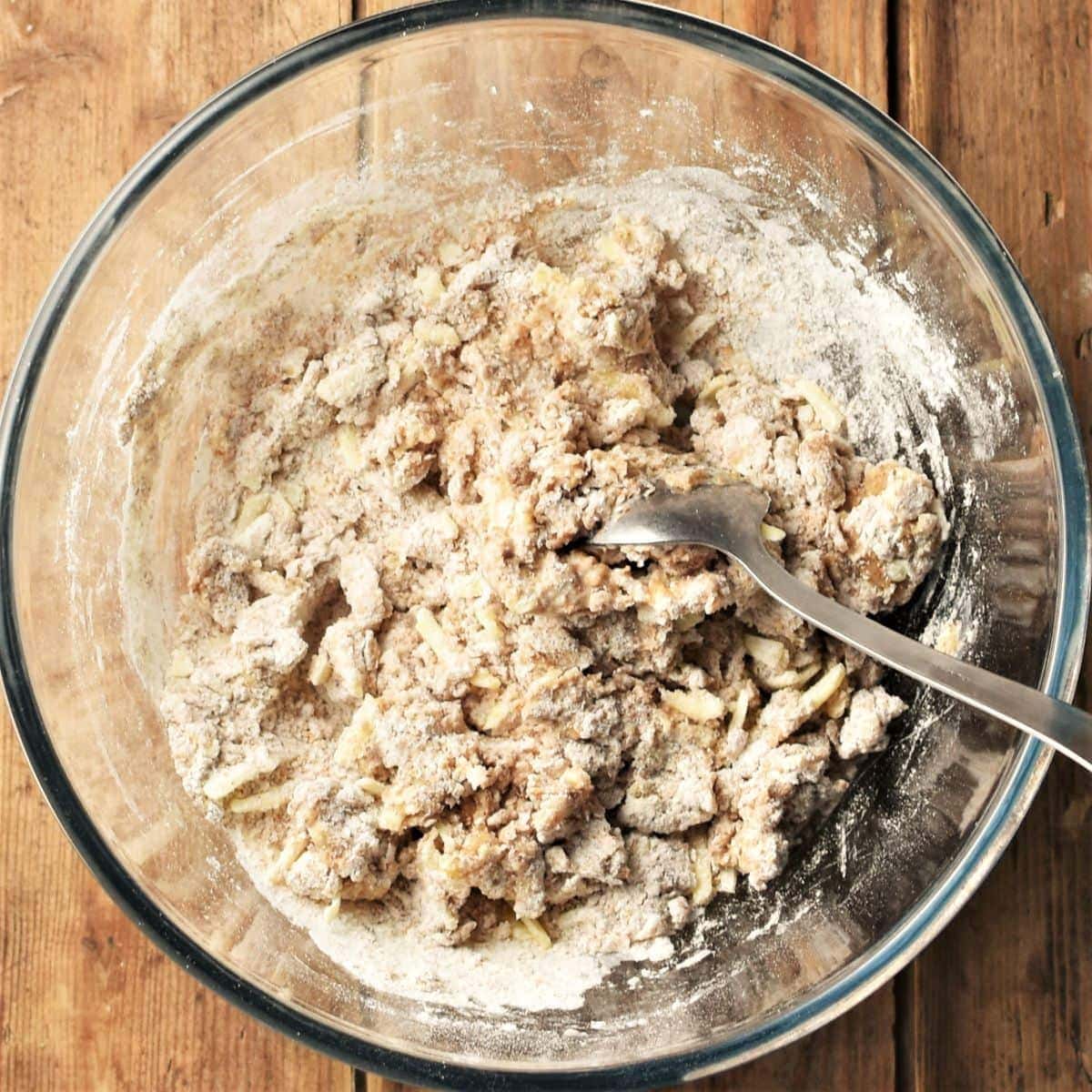 Making breadsticks batter in mixing bowl with spoon.