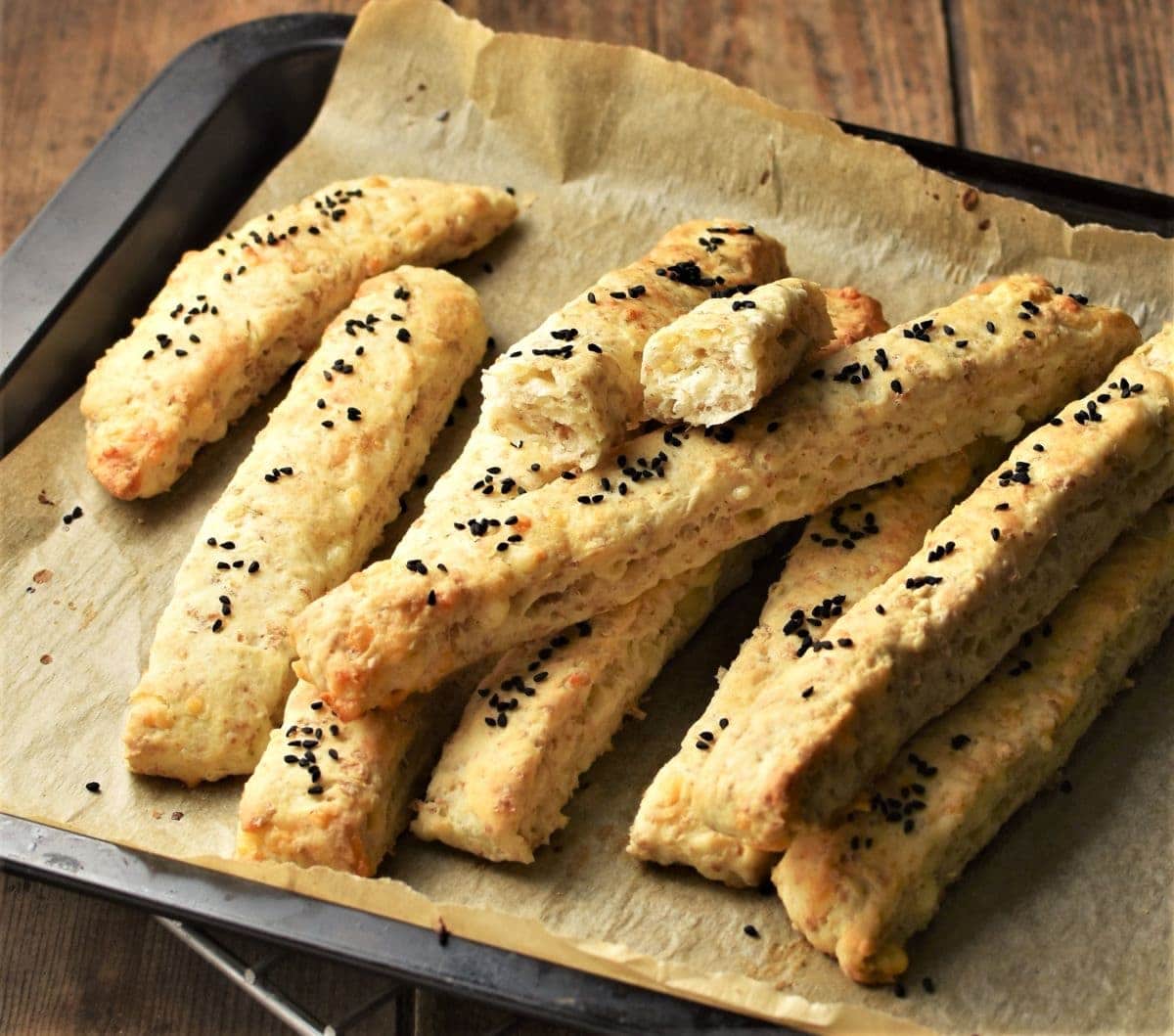 Side view of breadsticks on top of parchment.