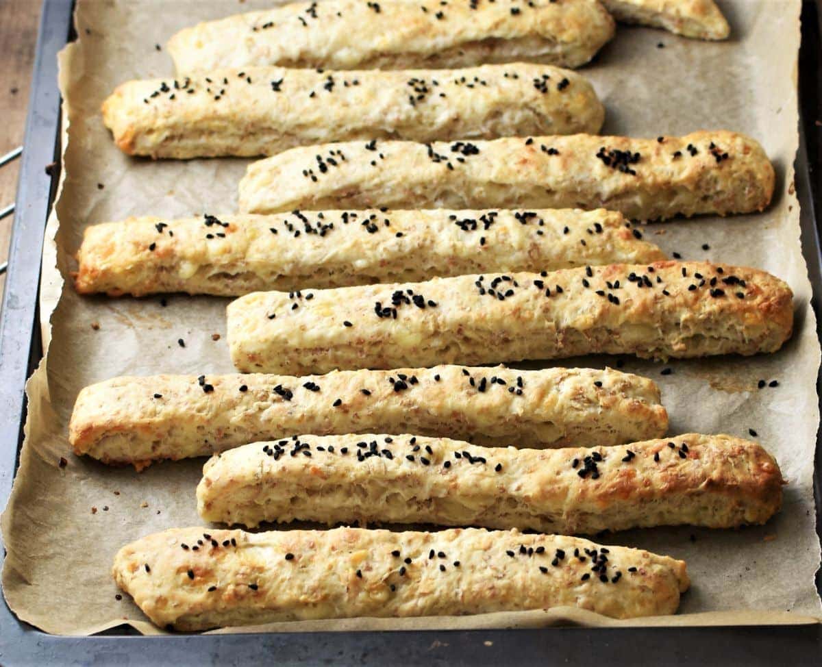 Close-up view of breadsticks on top of parchment.