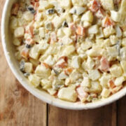 Top down partial view of potato salad in white bowl.