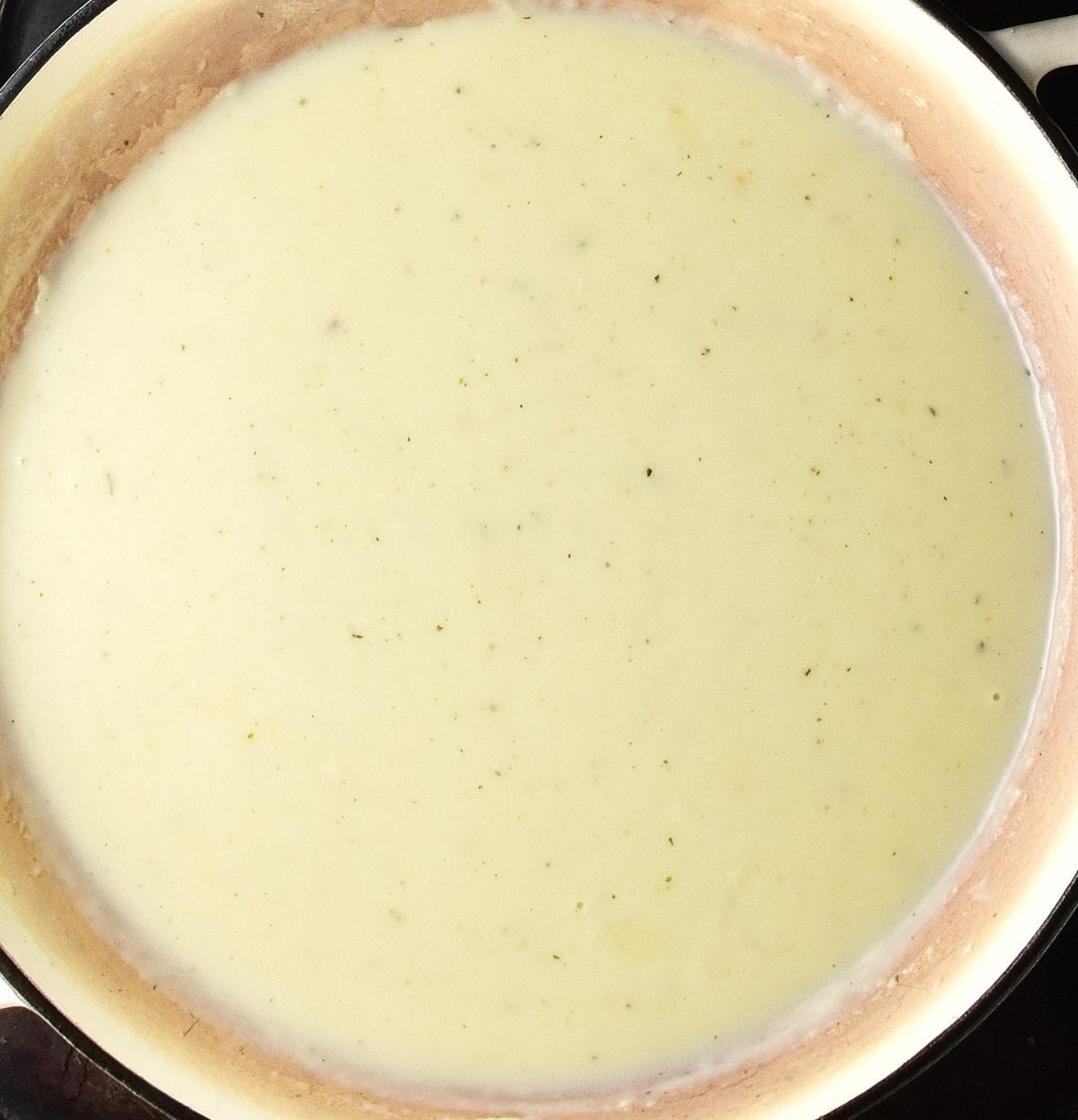 Creamy sauce in large shallow pan.