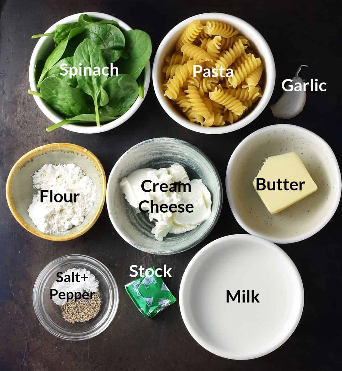 Creamy spinach pasta sauce ingredients in individual, small dishes.