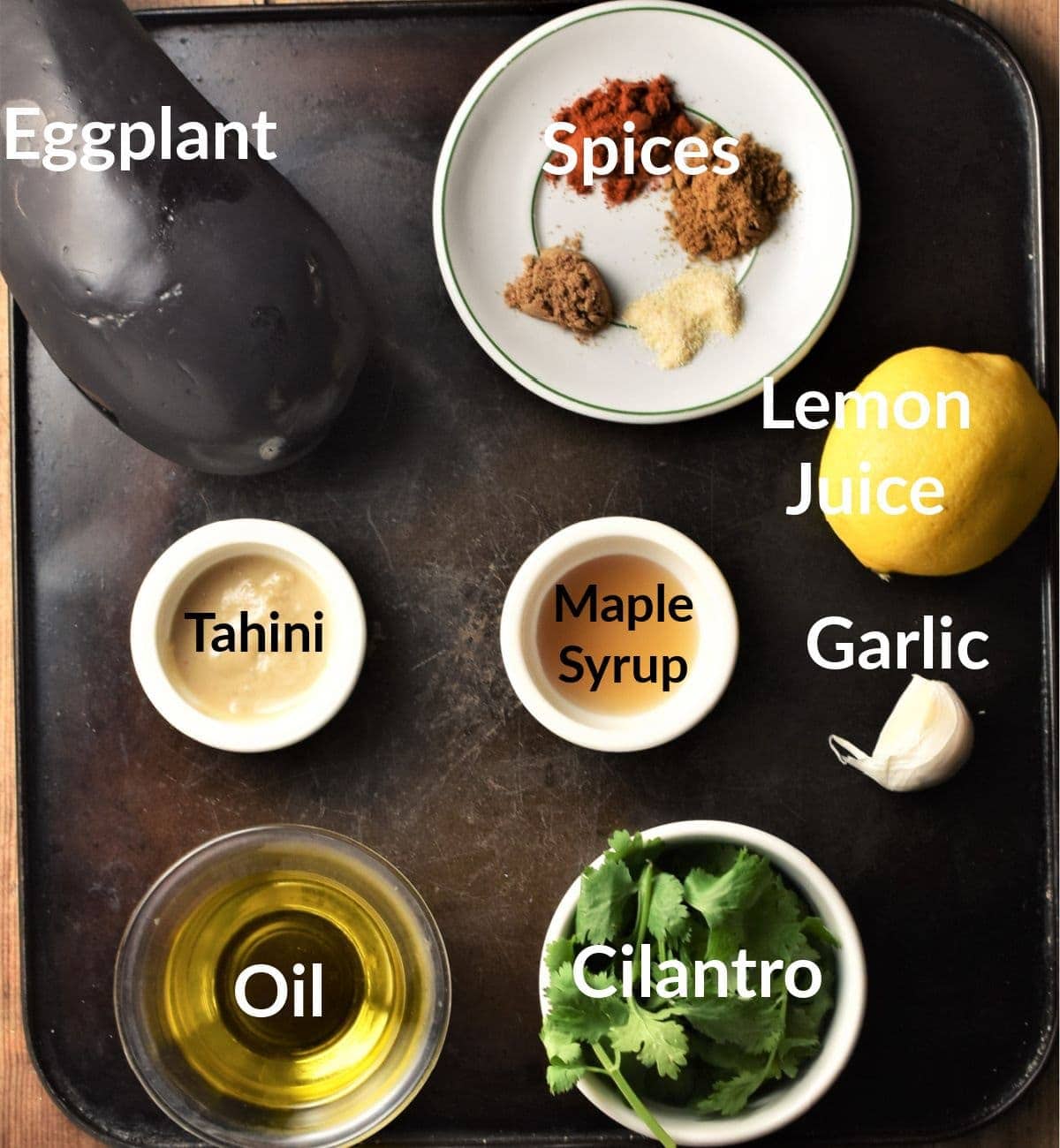 Eggplant dip ingredients in individual dishes.