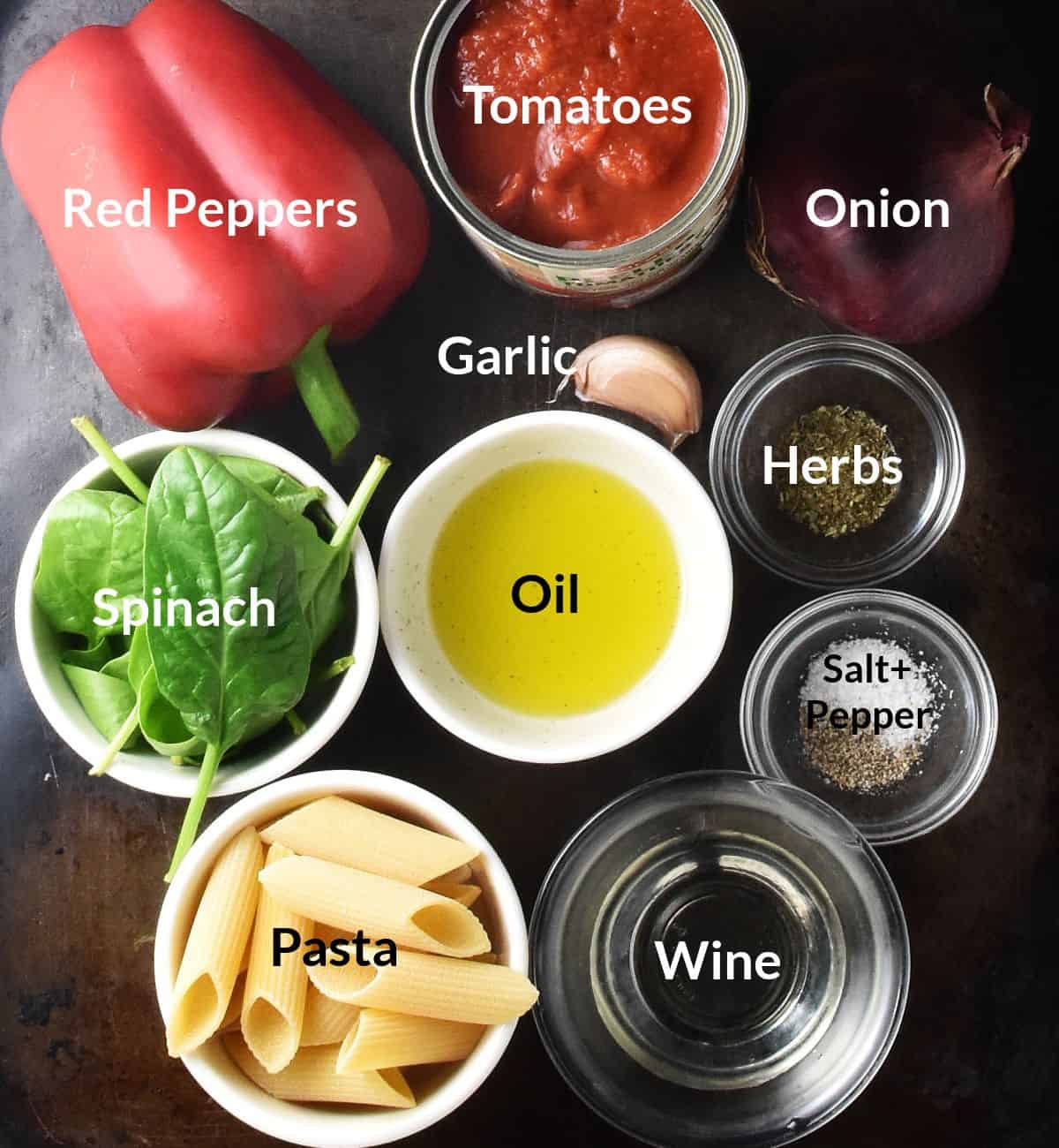Top down view of ingredients for red pepper tomato pasta sauce individual dishes.
