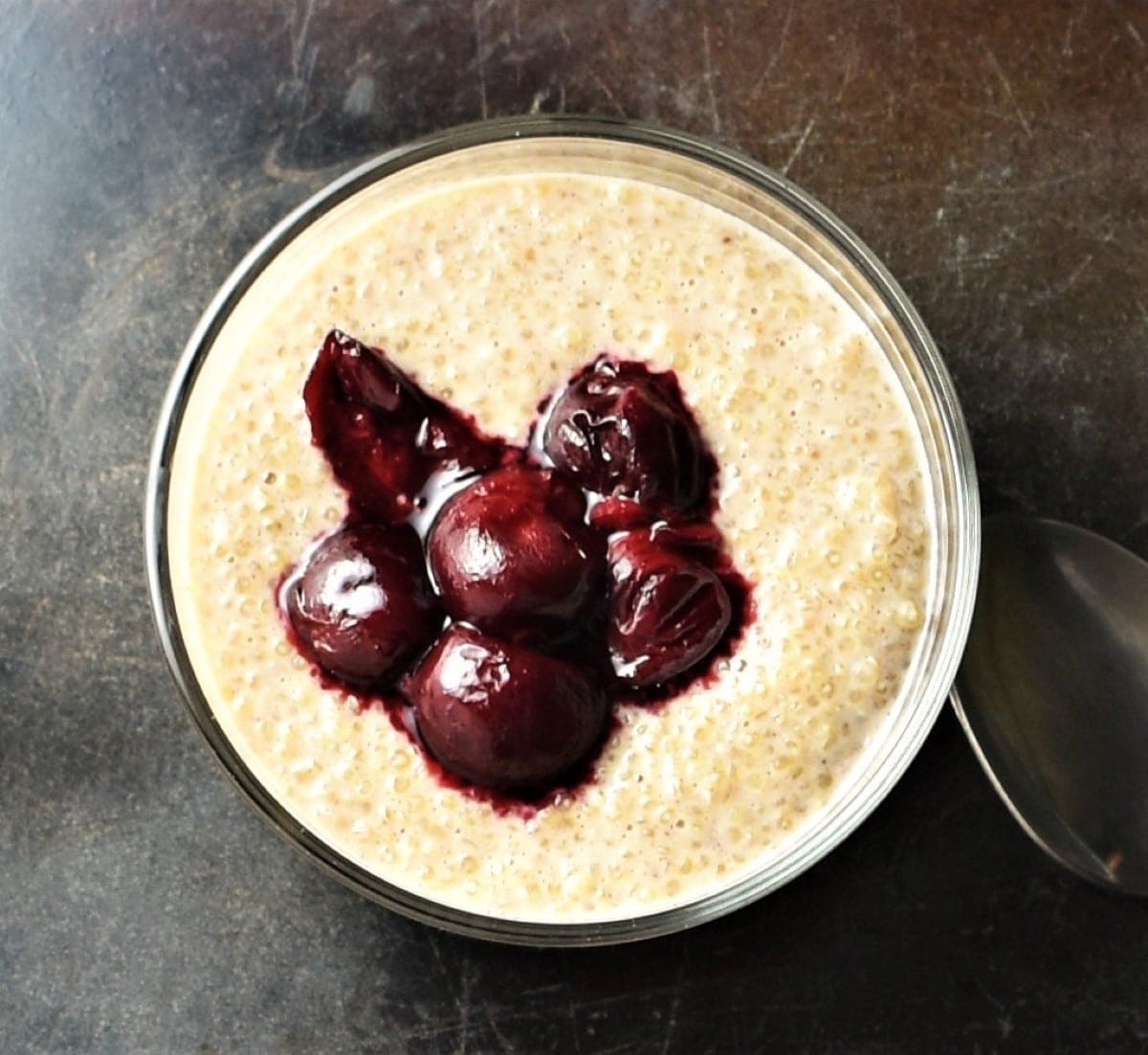 Quinoa pudding with fruit in round dish.