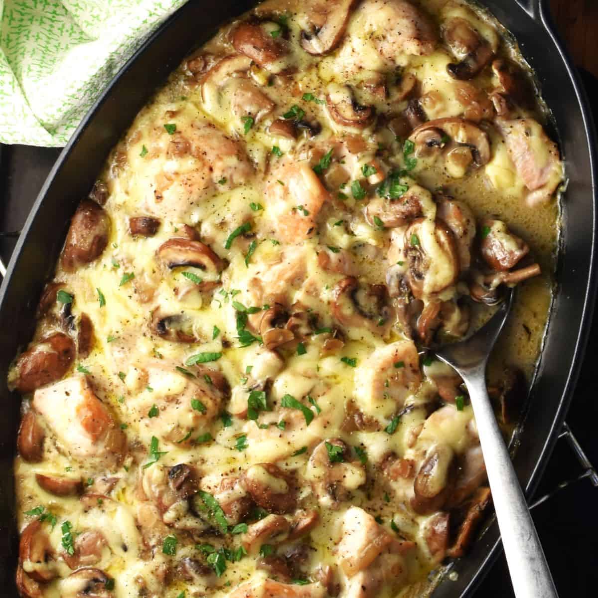 Top down view of chicken and mushroom casserole in oval dish.
