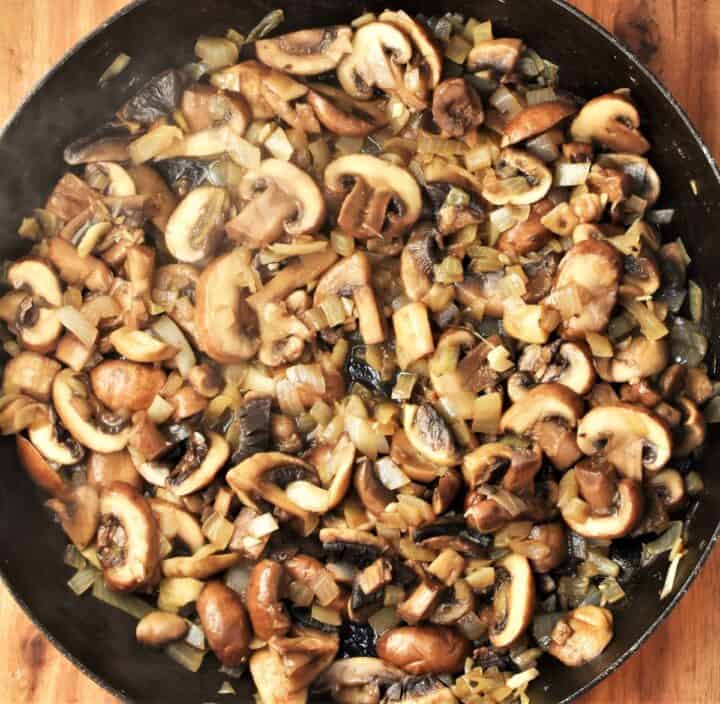 Frying chopped mushrooms and onion in large shallow pan.
