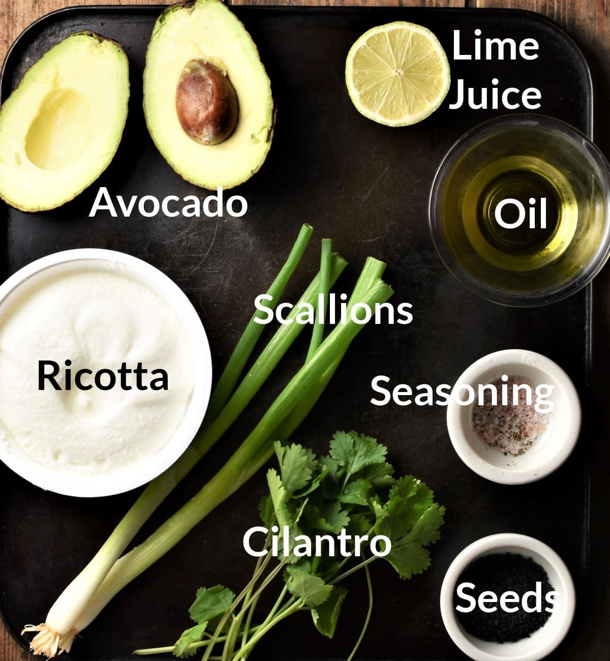 Ingredients for making avocado cheese toast topping in individual dishes.