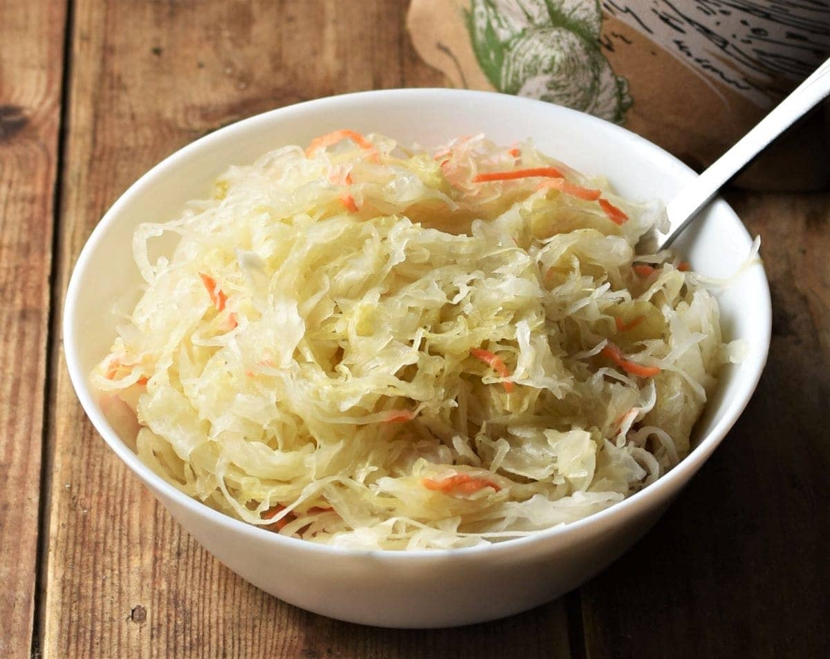 Sauerkraut in white bowl with fork.
