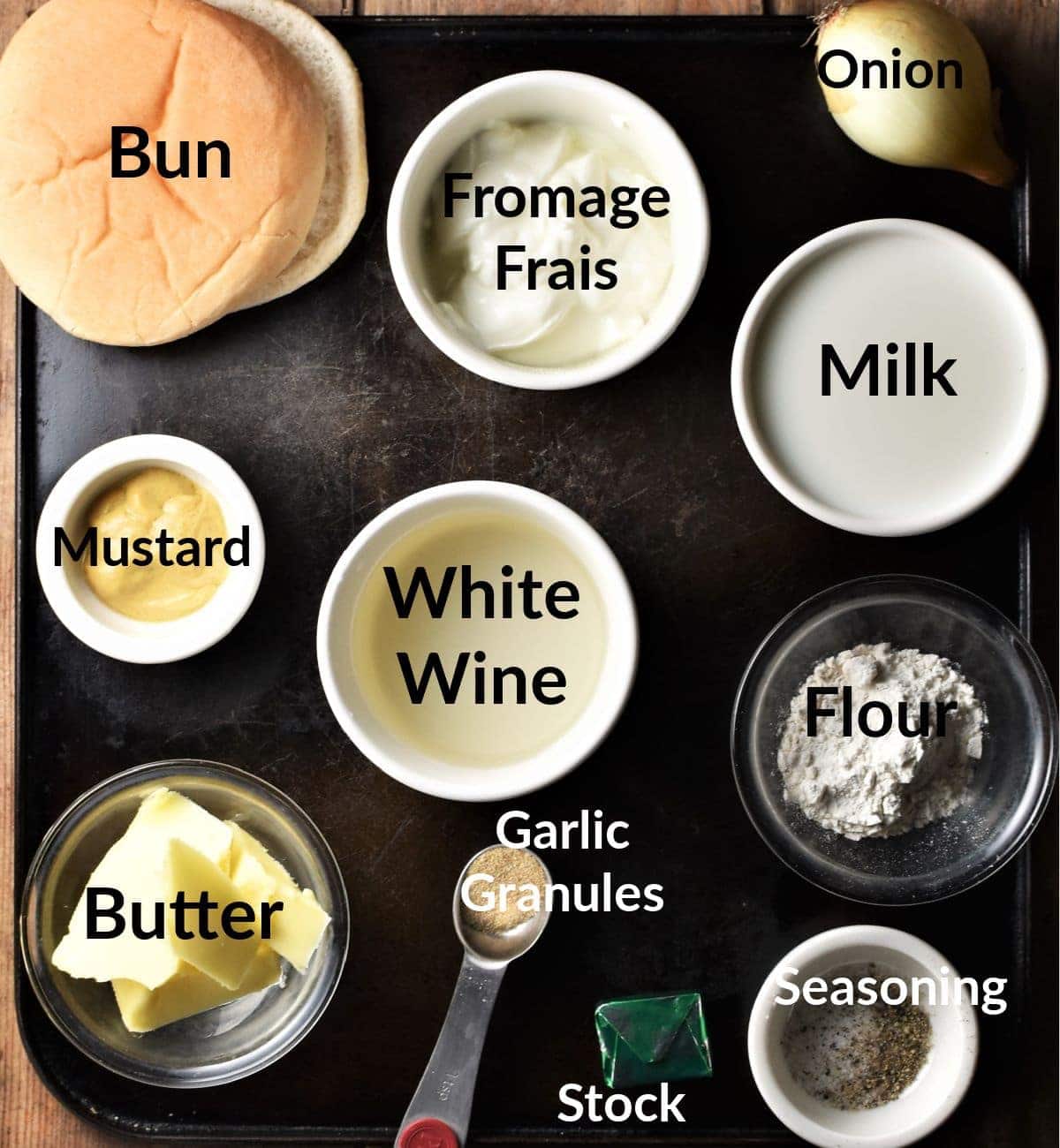 Meatballs and white sauce ingredients in individual dishes.