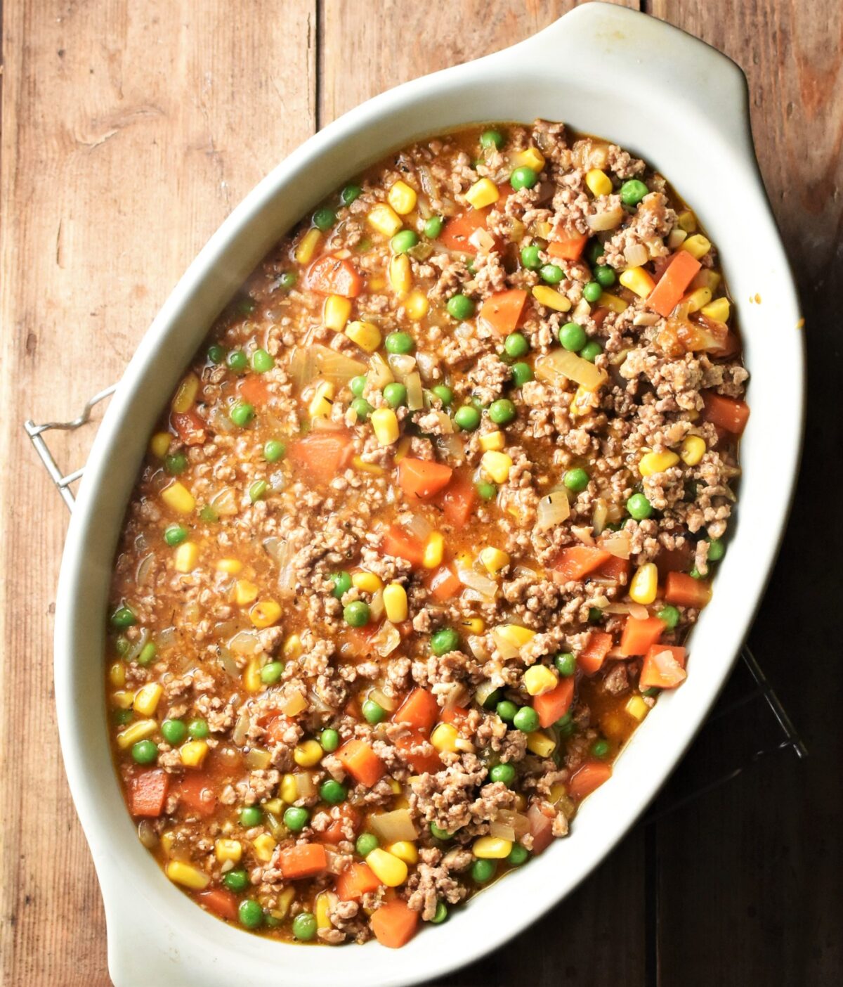 Turkey shepherds pie filling in green oval dish.