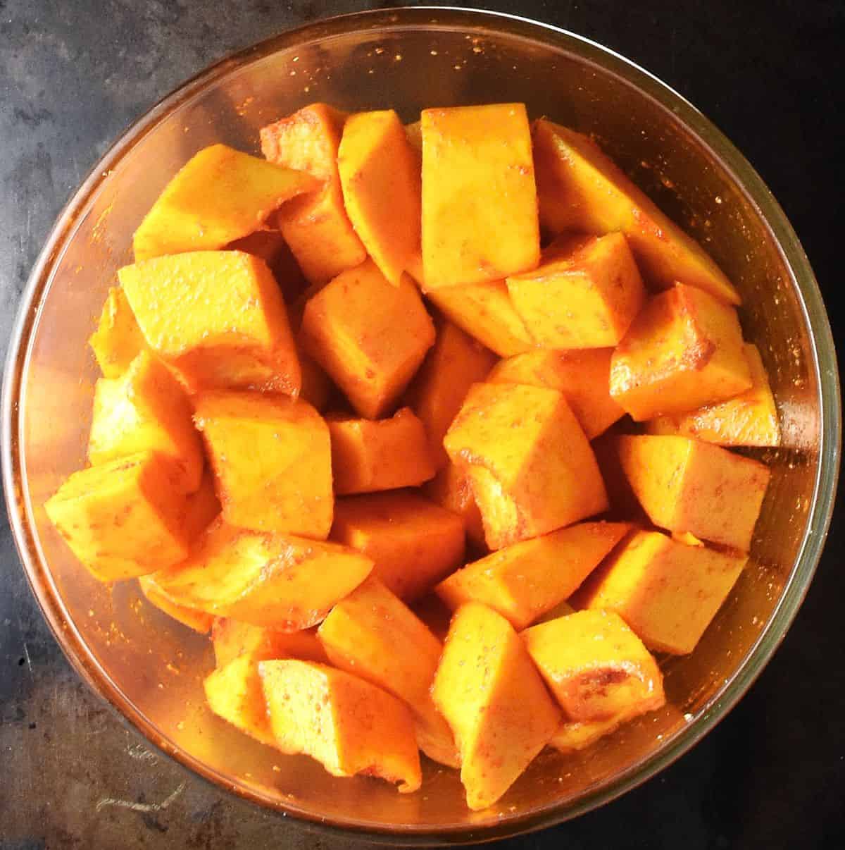 Cubed pumpkin in glass bowl.
