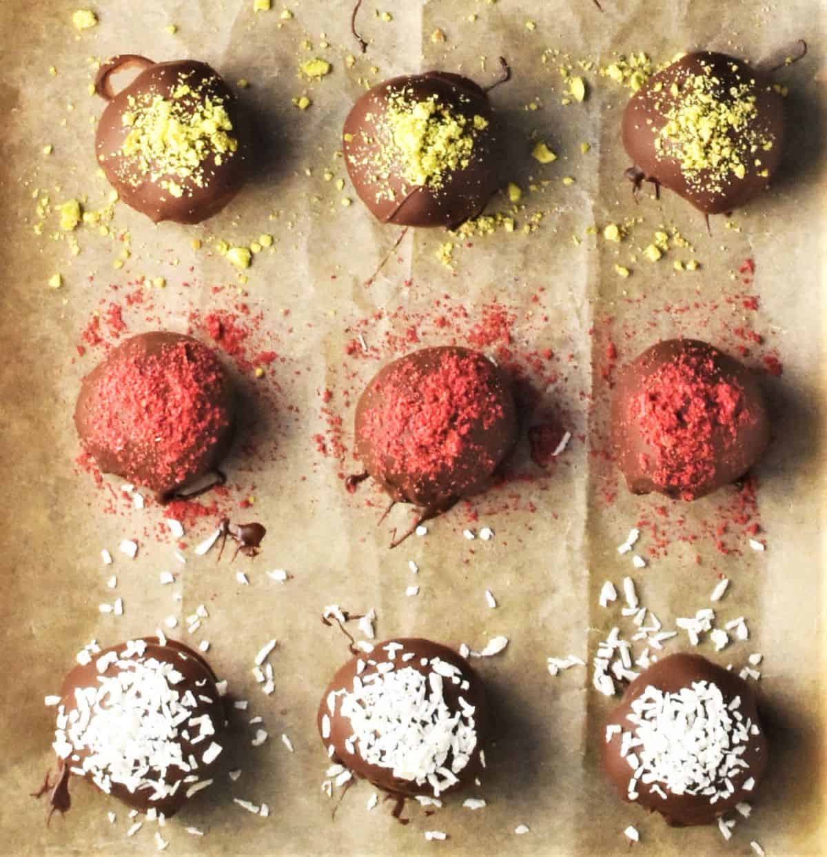 Top down view of 9 Christmas chocolate truffles on parchment.