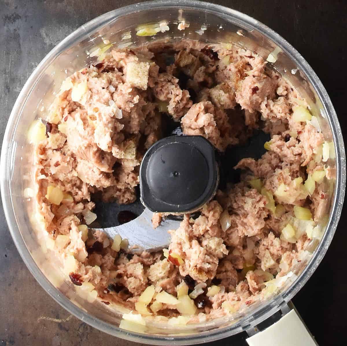 Vegan sausage stuffing mixture in food processor bowl.
