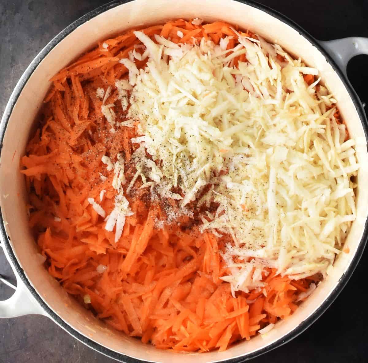Shredded carrot and celery root in white pot.