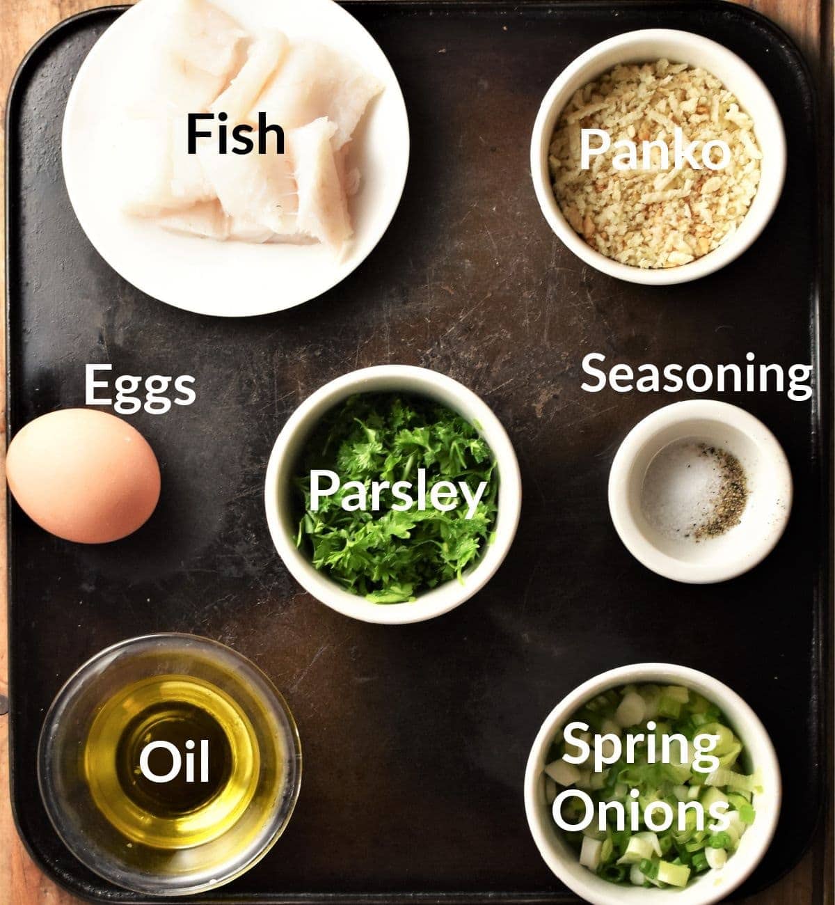 Fish cakes ingredients in individual dishes.
