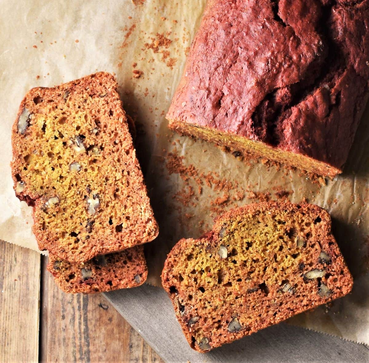 Top down view of slices of beet bread on top of parchment.