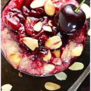 Top down view of overnight oats with cherries and almond flakes.
