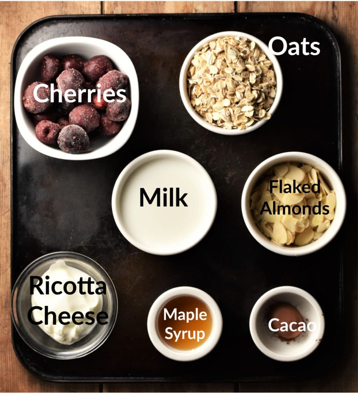 Cherry overnight oats ingredients in individual dishes.