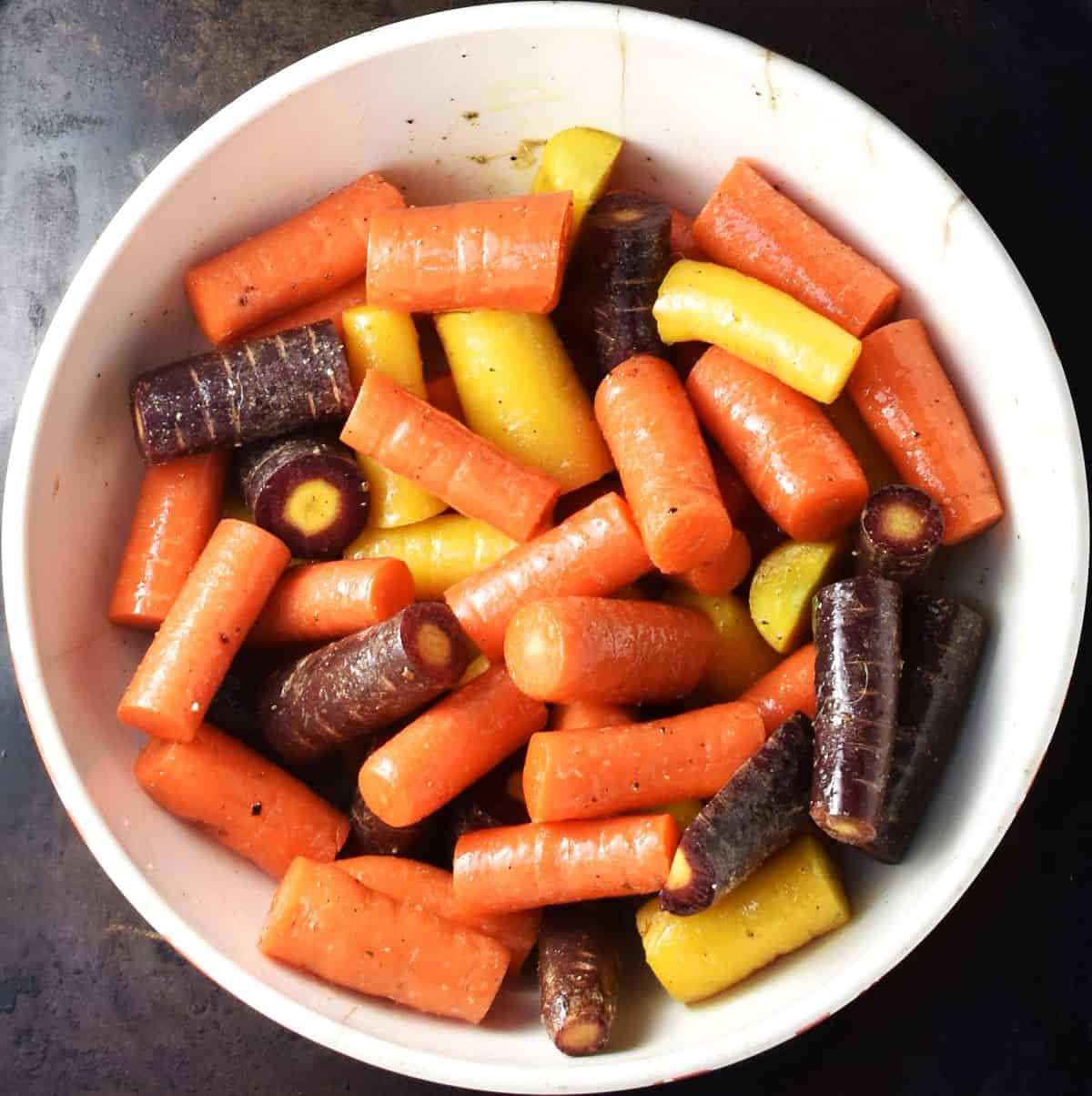 Carrot pieces in white bowl.