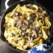 Top down view of mushroom pasta without cream in skillet.