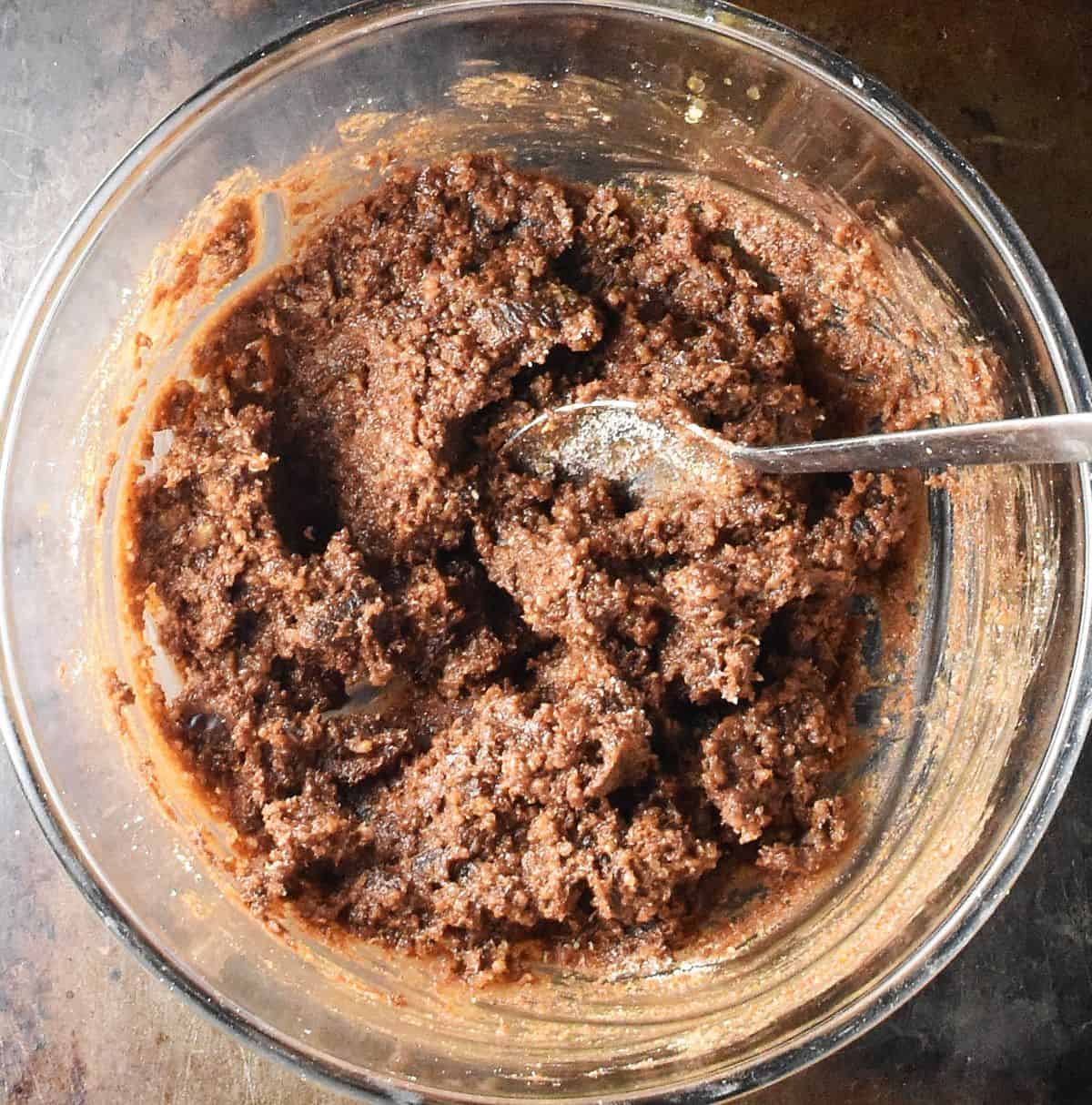 This quinoa chocolate mixture in glass bowl with spoon.