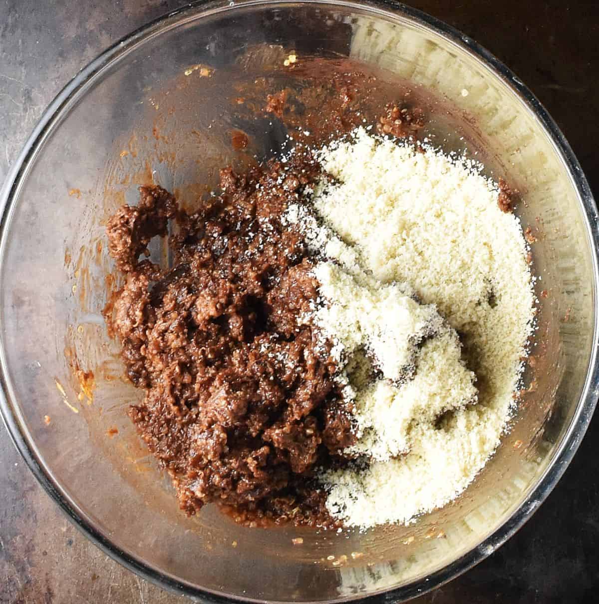 Quinoa ball mixture with almond flour in glass bowl.