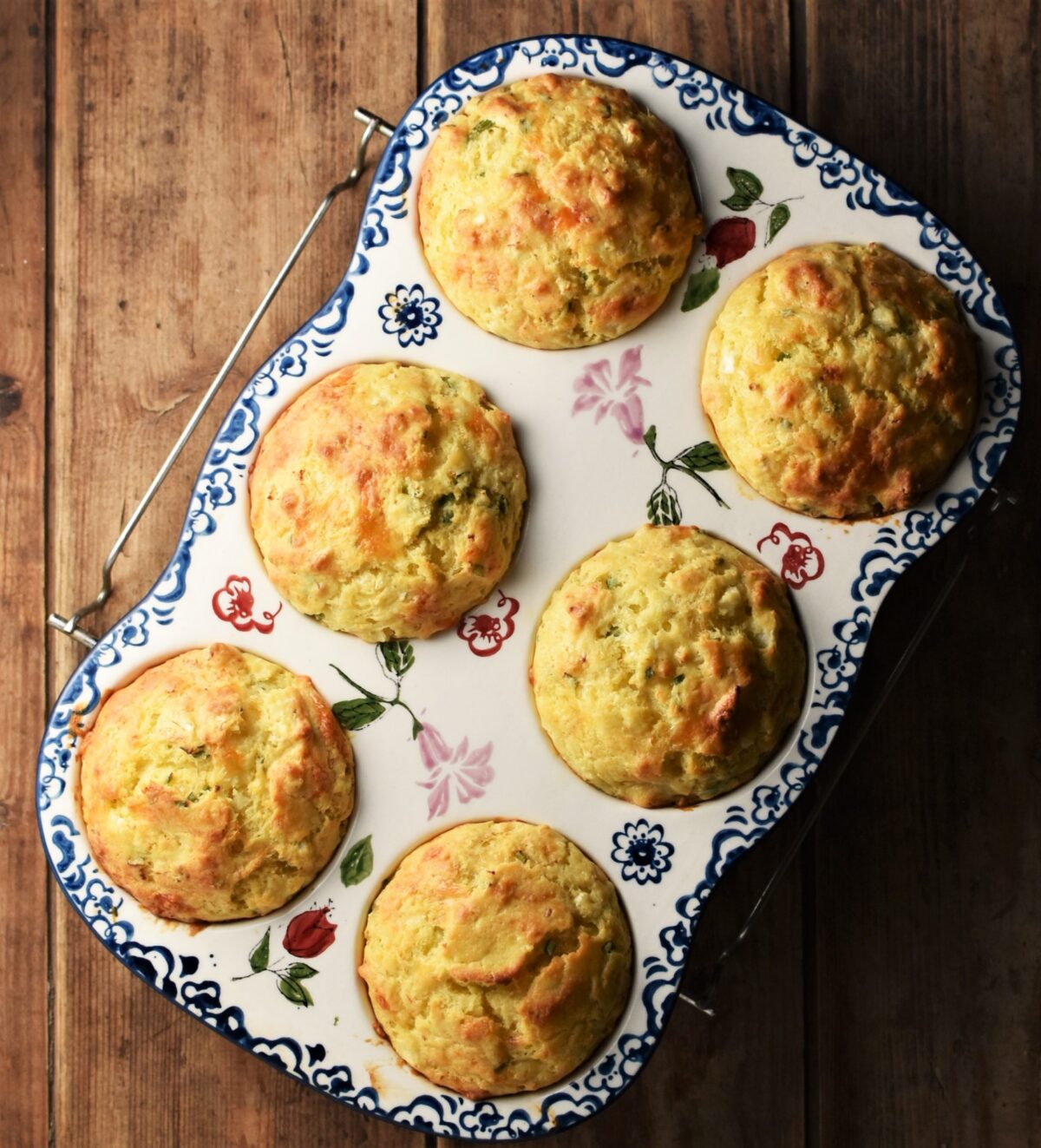 6 cauliflower muffins in ceramic white pan with blue flowery pattern.