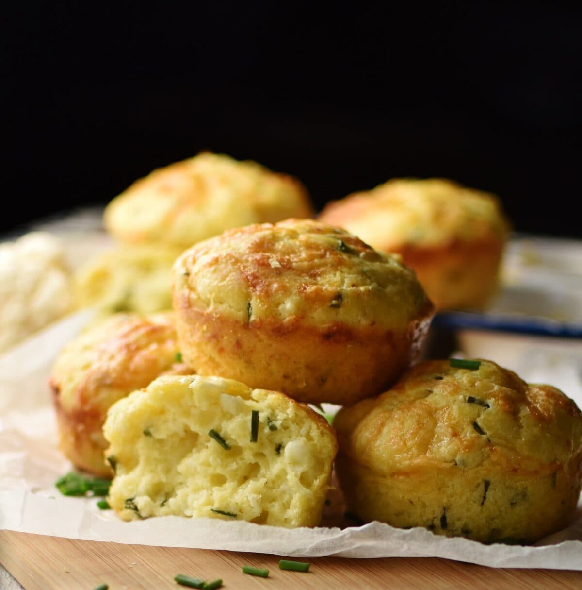 Side view of cauliflower muffins on top of baking paper.