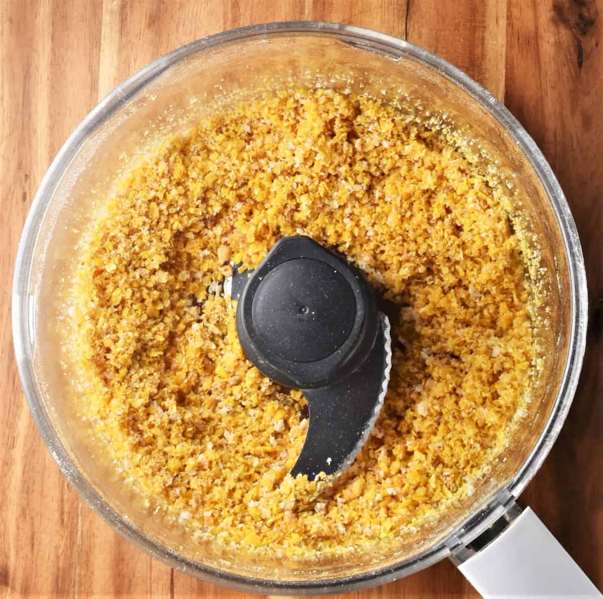 Crumbly cornflake mixture in food processor.
