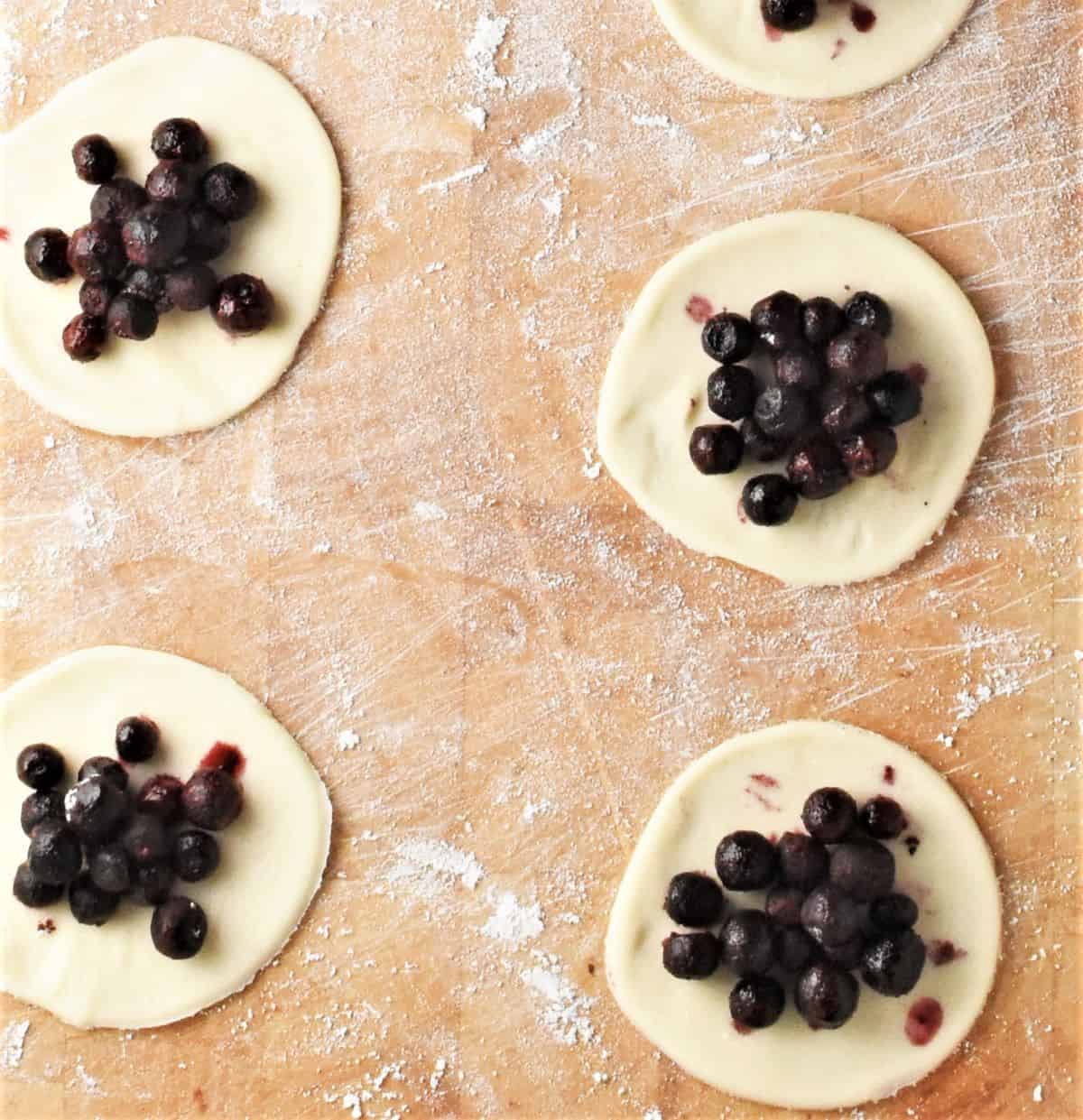 Pierogi rounds with blueberries in centre.