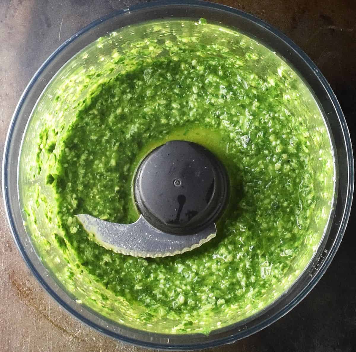 Pesto sauce in food processor bowl.