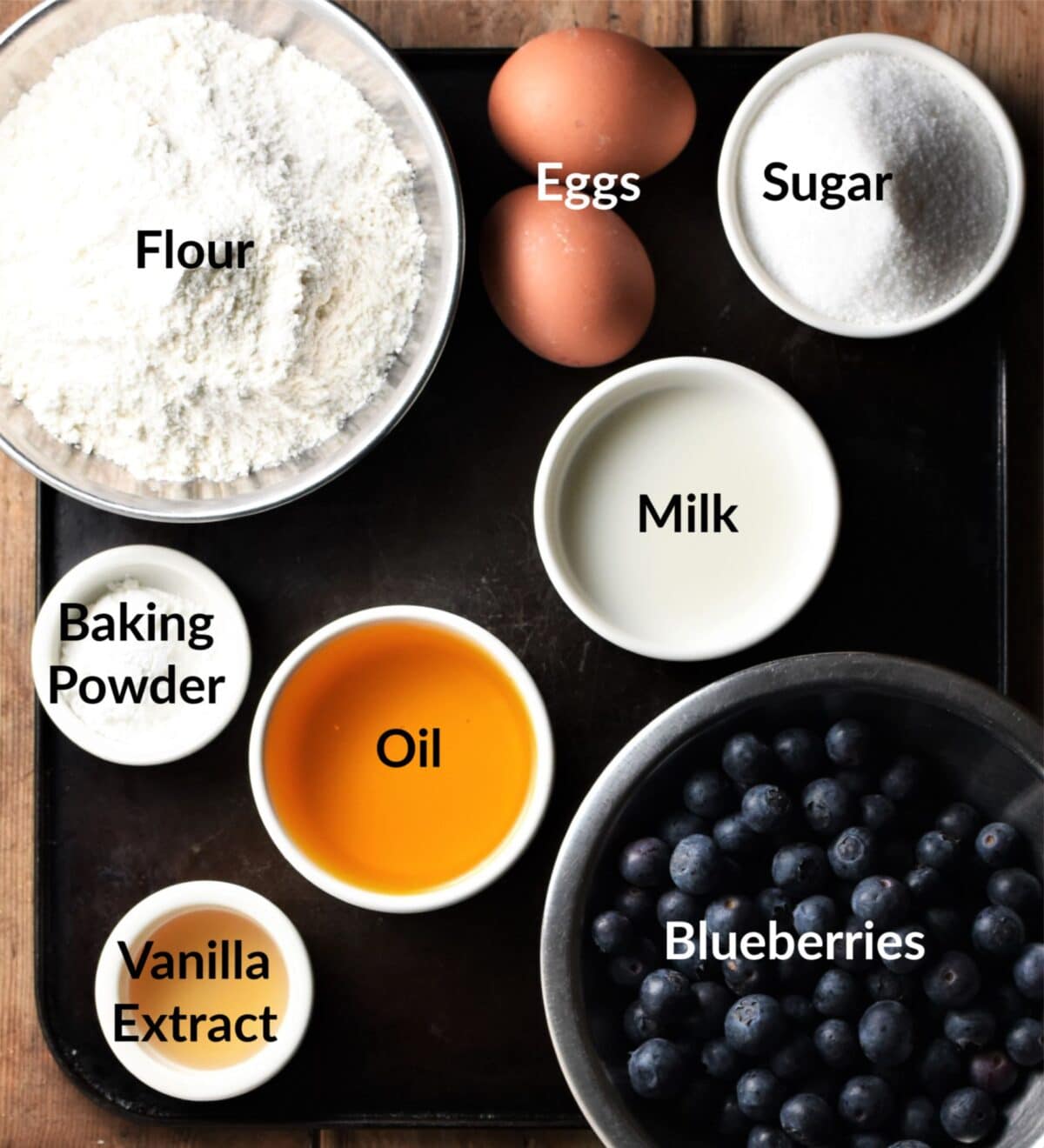 Blueberry cake ingredients in separate dishes.
