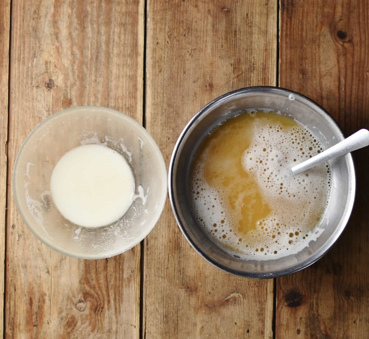 Potato starch in small bowl and water from potatoes in metal bowl with spoon.