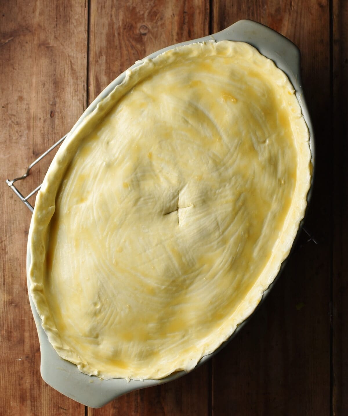 Uncooked pie in large oval dish. 
