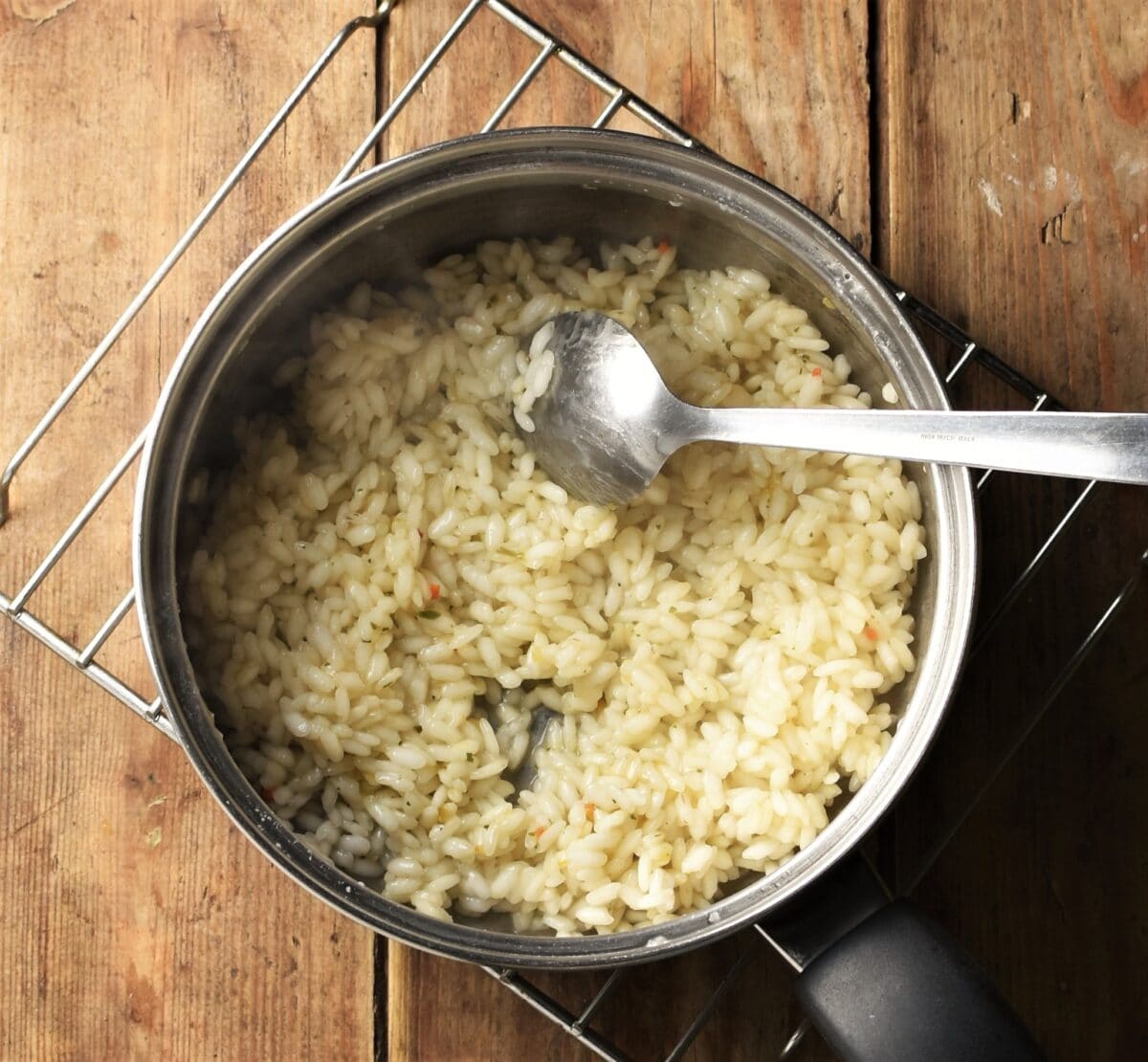 Rice in saucepan with spoon.