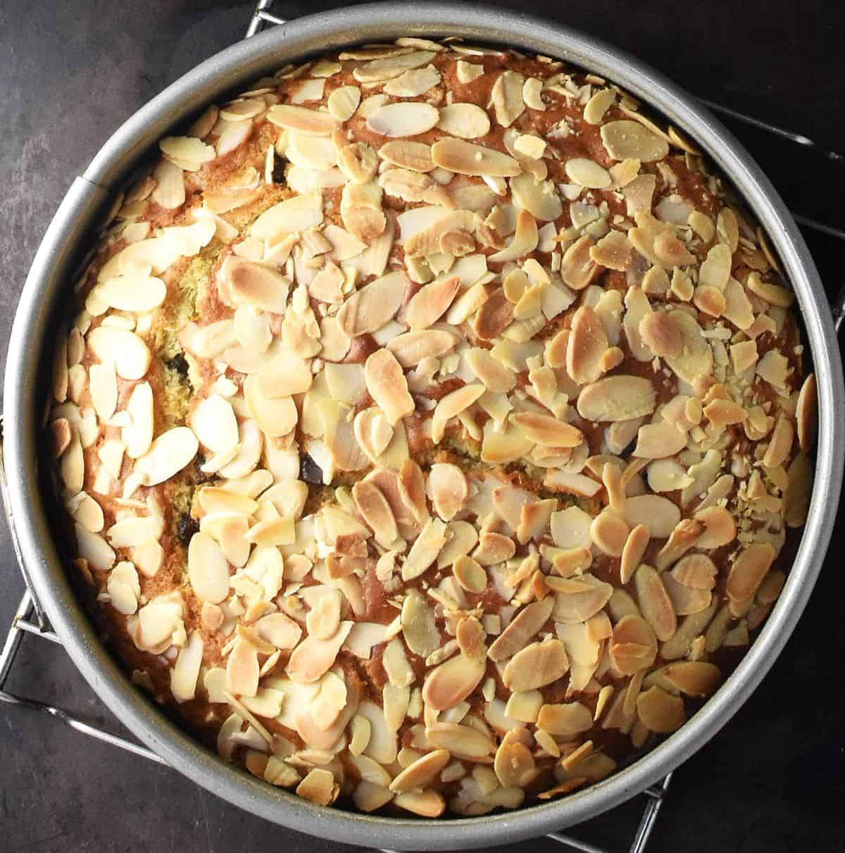 Top down view of baked marzipan cake in round tin.